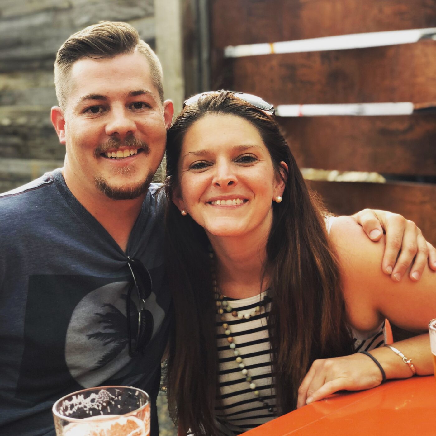 Jesse and Karlee at a bar, leaning in for a photo