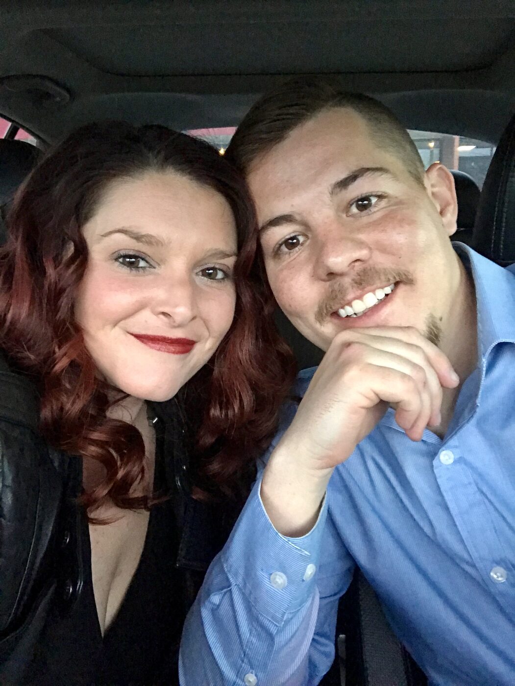 Jesse and Karlee in the front of the van, leaning together