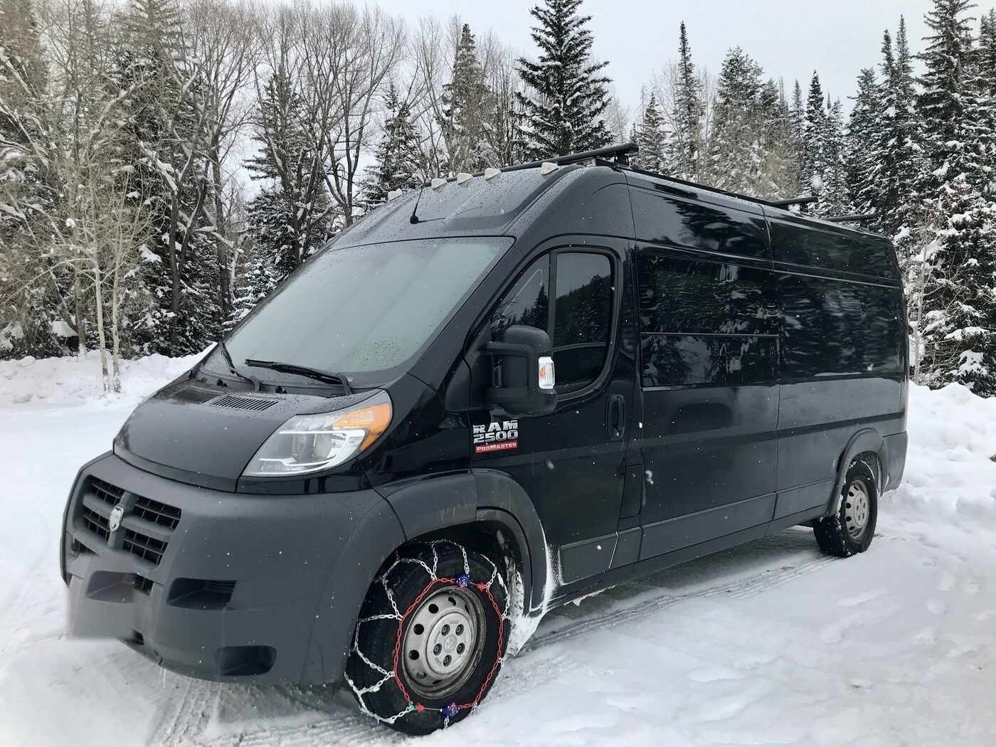 The van in deep snow with tire chains on