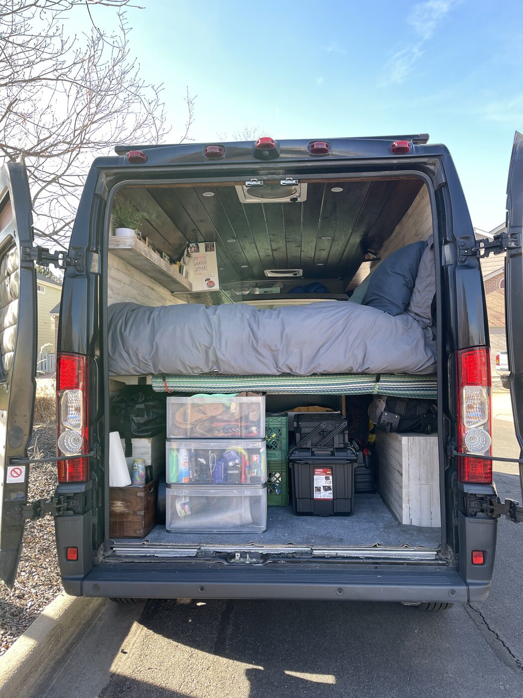 The van's rear garage packed floor to ceiling with gear